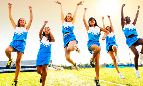 Cheerleaders jumping and cheering